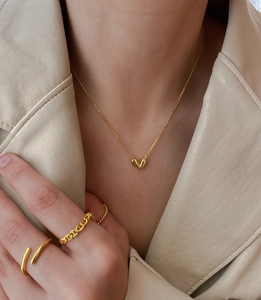 Detailed view of 925 sterling silver gold heart necklace with matching trendy gold rings