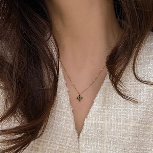 925 silver gold clover necklace with black zircon stones shown on a model