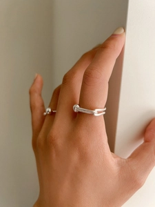 Detail of silver double-layered snake chain texture ring and minimalist pinky bead ring