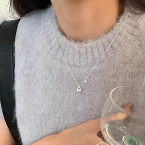 Elegant S925 sterling silver waterdrop pendant necklace worn on a female model