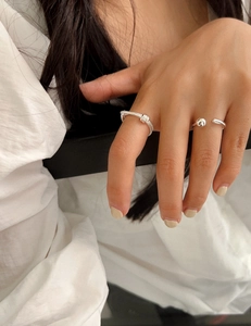 Detail of 925 sterling silver double-layered knotted ring and beaded open band on hand