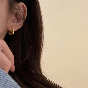 Golden geometric triangle hoop earrings for women with a stylish minimalist metal design