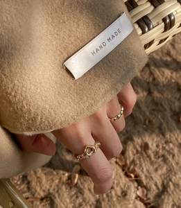 Close-up of S925 sterling silver gold rings set featuring hollow heart and wavy texture