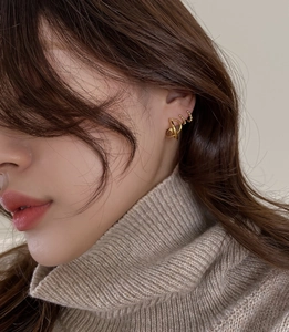 Close-up of gold S925 sterling silver twist knot earrings and bead hoops set for women