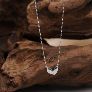 Minimalist 925 sterling silver heart necklace with double heart pendant on wooden branch
