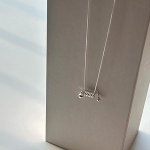 Minimalist 925 sterling silver spring spiral necklace with small beads on a sleek snake chain