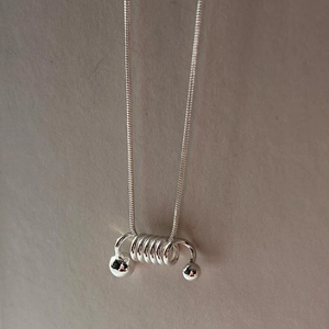 Minimalist 925 silver necklace with a unique spring spiral pendant and snake chain link