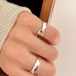 Minimalist 925 sterling silver irregular folded rings shown in a natural lifestyle setting