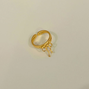 Detailed top view of a gold ribbon bow ring with an adjustable open double-line band