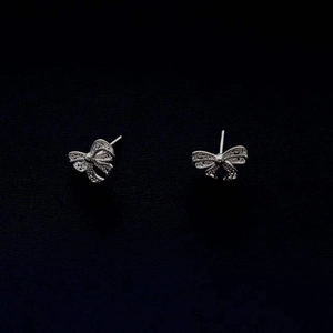 Elegant 925 sterling silver bow knot stud earrings with delicate openwork texture