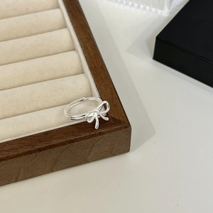 925 sterling silver bow ring with adjustable open band on a jewelry display tray