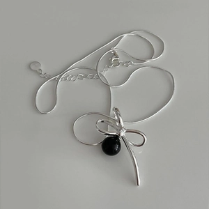 Elegant 925 sterling silver necklace with a black bead pendant and a ribbon bow charm