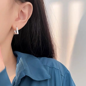 Minimalist S925 sterling silver rectangular hoop earrings shown on a model