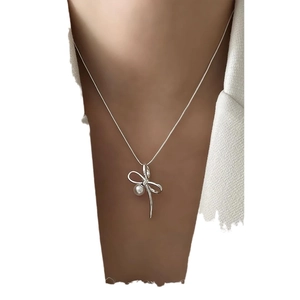Elegant 925 sterling silver bow necklace with a white pearl and sparkling accents