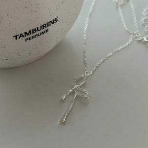 Collana in argento 925 con ciondolo a fiocco e strass su sfondo bianco materico
