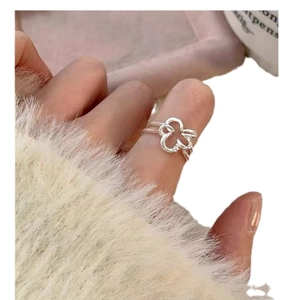 925 sterling silver hollow flower ring with zircon stone on finger of white sweater
