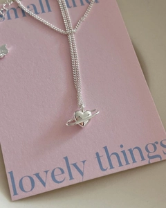 Macro detail showing S925 sterling silver hallmark on the heart planet pendant necklace