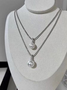 Detail of 925 silver beaded necklaces with white crystal pearl pendants on jewelry stand