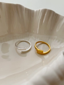 Minimalist 925 silver wrap rings in gold and silver finish on a ceramic tray
