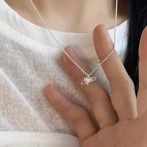 S925 sterling silver heart planet pendant necklace shown on a model's collarbone