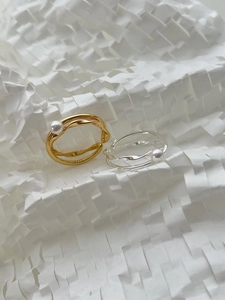 Macro detail showing S925 hallmark on minimalist silver and gold pearl rings