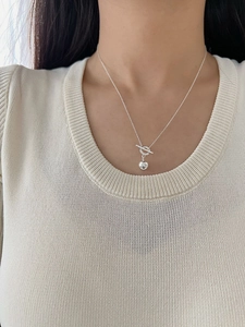 Close-up of S925 sterling silver OT toggle necklace with a polished sphere pendant on neck