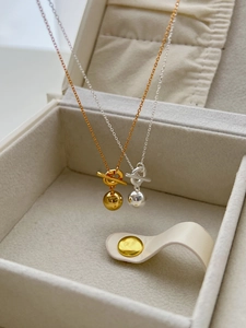 Detail of S925 silver toggle clasp necklace with polished bead pendant in gold and silver