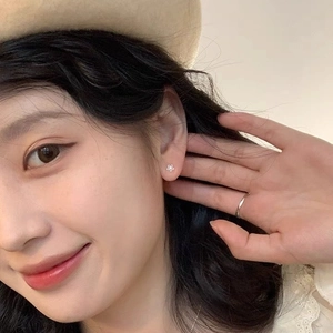 Minimalist S925 sterling silver sunflower stud earrings worn by a model for daily style