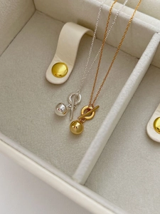 Detail of minimalist S925 sterling silver ball necklaces with OT clasp in gold and silver