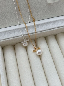 Detail of S925 silver and gold-plated twist pearl necklaces in a jewelry tray