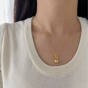 Minimalist S925 sterling silver gold necklace featuring a ball pendant and OT toggle clasp