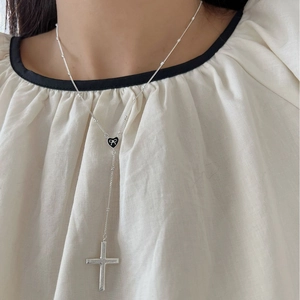Sterling silver Y-shaped necklace with black heart and cross pendant on a model