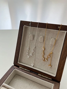 Detailed view of adjustable heart pendants in gold and silver finish with zircon stones