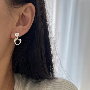 925 Sterling silver double heart earrings with hollow cutout design on female model