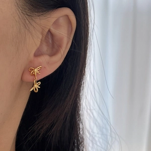 Exquisite gold S925 silver double-layered ribbon bow earrings worn by a model