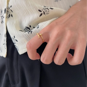 Elegant minimalist adjustable gold ball open ring worn on a finger for a chic daily style