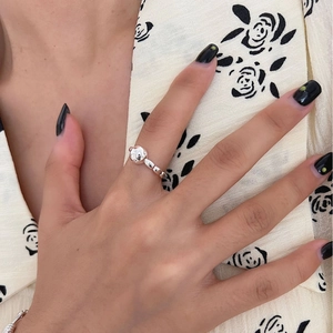 Silver bead ring with cute bear charm worn on finger for a stylish minimalist look