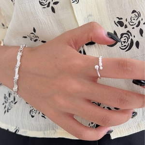 Minimalist 925 sterling silver open ring with gold ball design on female hand