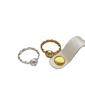 Polished gold and silver ball rings with wave design and white leather accessory