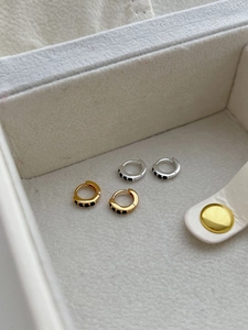 Close-up of S925 sterling silver hoop earrings with black zircon in gold and silver