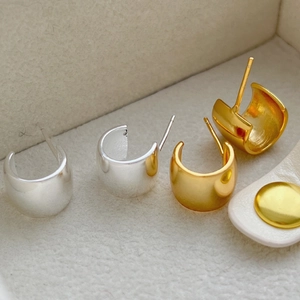 Set of gold and silver minimalist chunky C-shaped hoop earrings in a jewelry box
