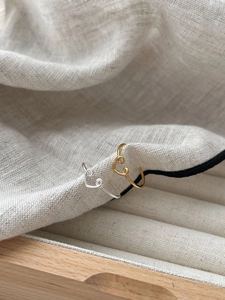 Detail shot of heart-shaped adjustable open rings in gold and silver finish