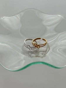 Detailed shot of double-layered twist wave rings in gold and silver finish