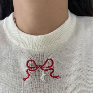 925 sterling silver croissant pendant necklace shown on a model with white sweater
