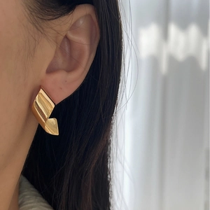 925 silver golden twisted ribbon earrings on female model with minimalist geometric design