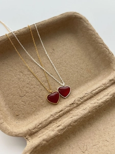 Detail of red heart pendants on gold and silver 925 sterling silver chain necklaces