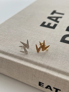 Macro detail of 925 sterling silver bamboo leaf ear cuff with brushed metallic texture