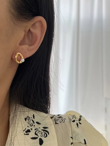 Close-up of S925 sterling silver earring with irregular gold ring and freshwater pearl