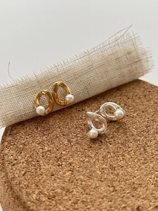Artistic S925 silver twist earrings with irregular natural freshwater pearls on cork stand