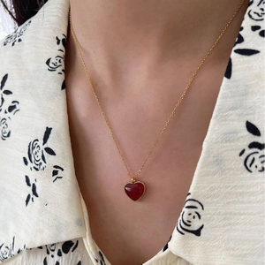 925 silver gold-plated necklace with a red heart agate pendant worn by a model